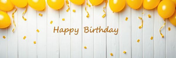 Happy birthday celebration with yellow balloons and confetti on a wooden backdrop photo
