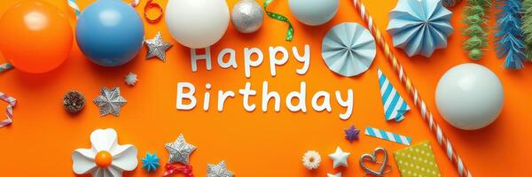 Colorful birthday decorations on an orange background with balloons and crafts displayed for a festive celebration photo