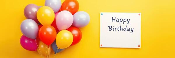 Colorful balloons and a birthday sign create a festive atmosphere for a celebration photo