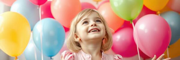 Happy child celebrating with colorful balloons at a festive party indoors photo