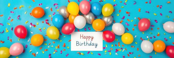 Colorful birthday celebration with balloons and confetti on a bright blue background photo