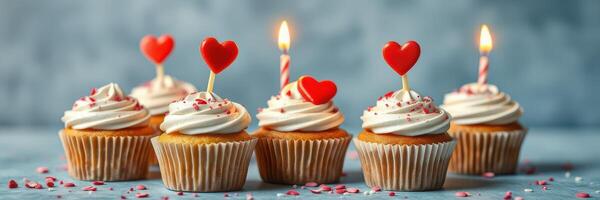 Colorful cupcakes adorned with heart toppers and candles celebrate love during a joyful gathering photo