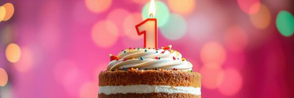 Birthday celebration featuring a one year cake with colorful icing and festive background photo