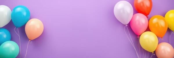 Colorful balloons arranged on a vibrant purple background for celebration decorations in a festive setting photo
