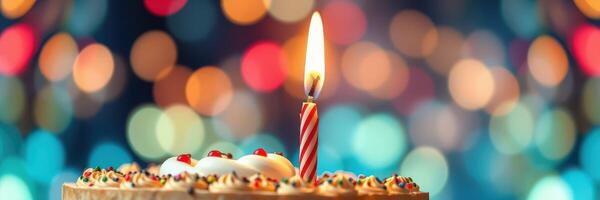 Bright candle on a festive cake surrounded by colorful lights during a celebration photo