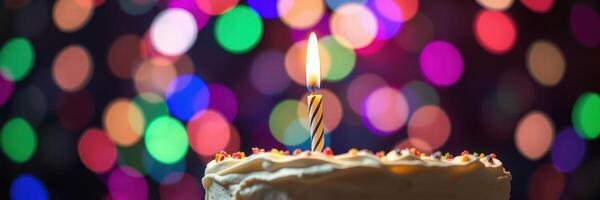 Colorful birthday celebration with a cake and candle glowing in the festive atmosphere photo