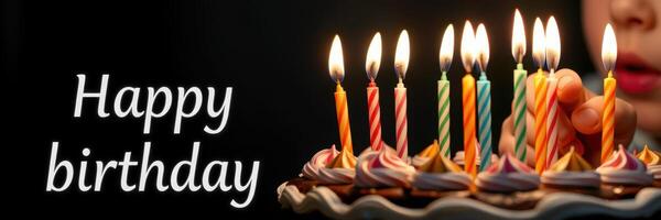 Celebration with colorful birthday candles glowing on a cake during a festive gathering photo