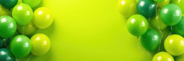 Colorful green and yellow balloons arranged against a bright green background for a festive celebration photo
