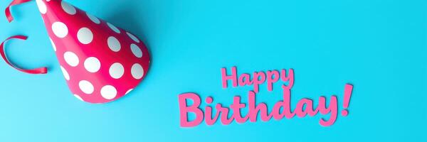 Colorful birthday celebration with polka dot party hat and festive greeting on bright blue background photo