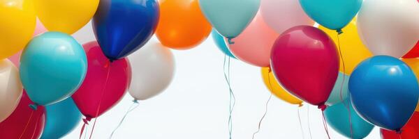 Colorful balloons fill the air during a festive celebration, creating a joyful atmosphere outdoors with bright colors photo