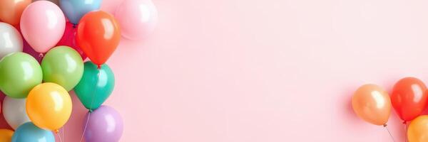 Colorful balloons create a festive atmosphere against a soft pink background for celebrations and events photo