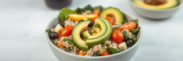 Fresh quinoa salad with avocado, tomatoes, and spinach in a modern kitchen setting photo