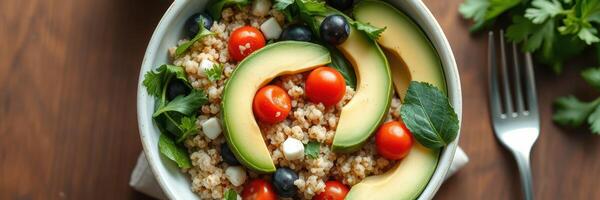 Healthy quinoa salad with fresh vegetables served in a rustic bowl on a wooden table with green herbs photo