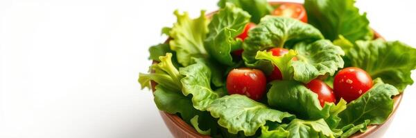 Fresh salad with vibrant cherry tomatoes and crisp lettuce in a wooden bowl set on a white surface photo