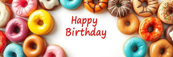 Colorful assortment of donuts decorated for a birthday celebration with cheerful message photo
