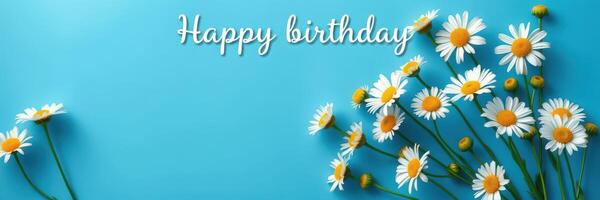 Bright daisies celebrate joyful birthday wishes against a tranquil blue background with playful typography photo