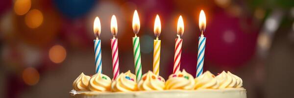 Birthday cake with colorful candles lit, celebrating a special occasion with friends and family photo