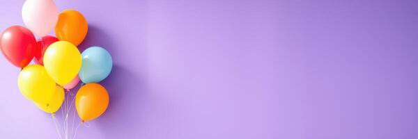 Colorful balloons in various shades float against a vibrant purple background, ideal for celebrations and festive occasions photo