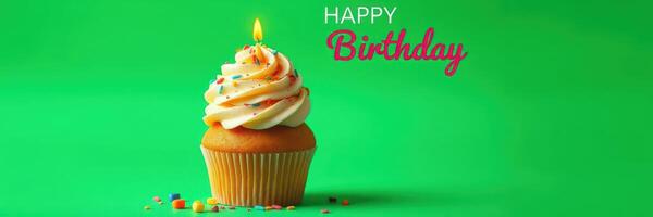 Festive birthday cupcake with frosting and candle against bright green background photo