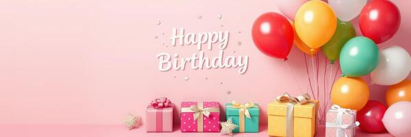 Colorful birthday celebration setup with balloons and wrapped gifts against a pink background for a joyful event photo