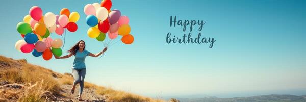 Joyful celebration of a birthday with colorful balloons in a mountainous landscape under a bright sky photo