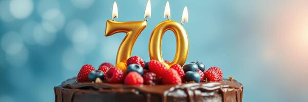 Celebrating a milestone with a vibrant chocolate cake adorned with 70 candles and fresh berries photo