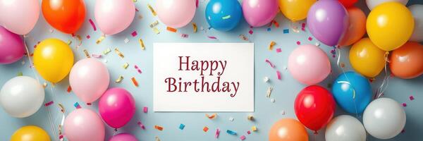 Colorful birthday decorations with balloons and a cheerful greeting on a light blue background for a festive celebration photo