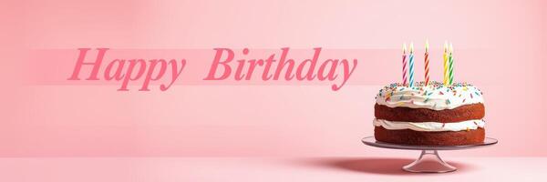 Birthday celebration with a decorated cake and candles on a pastel pink background for a festive atmosphere photo