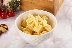 Crushed parmesan cheese in the bowl photo