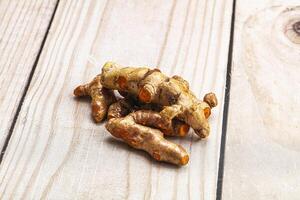 Fresh young Tumeric root heap photo