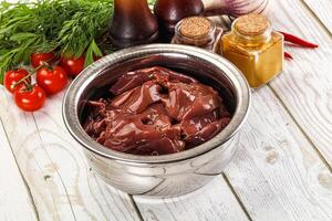 Raw chicken liver uncooked in the bowl photo