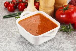 Hot tomato soup with diced chicken photo