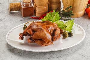 Baked small chicken with spices photo