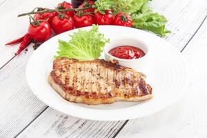 Grilled pork steak with ketchup photo