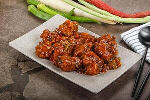 Manchurian chicken with sauce and spices photo