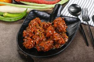 Manchurian chicken with sauce and spices photo