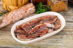 Canned anchovy with oil in the bowl photo