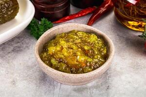 Souce gherkin relish with marinated cucumbers photo