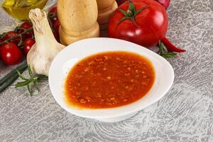 Hot tomato soup with diced chicken photo