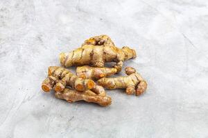 Fresh young Tumeric root heap photo