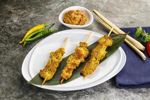 Thai meat skewer Satay with sauce photo