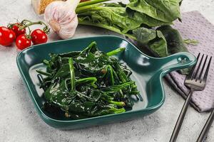 Coocked green spinach with oil photo