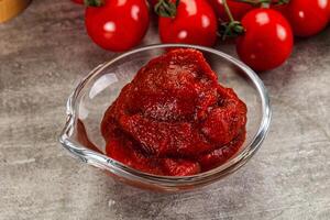 Red tomato paste in the bowl photo