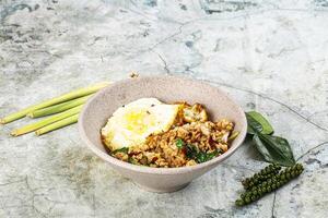 Rice with minced meat and basil photo