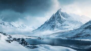 A snowy mountain range with a body of water in the foreground photo