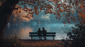 A couple is sitting on a bench by a lake, enjoying the peaceful scenery photo