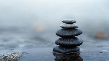 A stack of rocks on a body of water photo