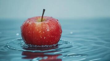 A red apple is floating in a body of water photo