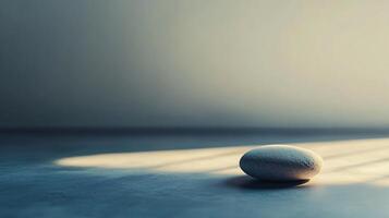 A small white rock sits on a grey floor photo