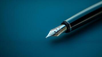 A pen with a black body and silver tip is on a blue background photo